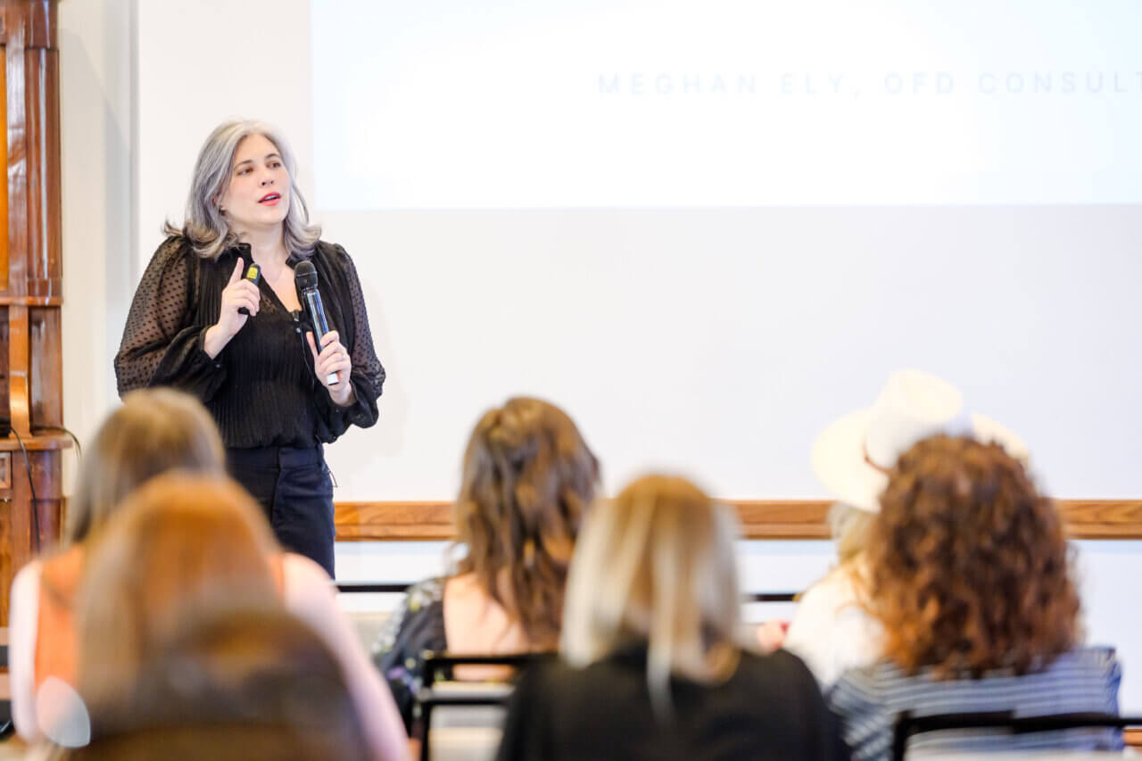 Meghan Ely speaking on stage; featured speaker for Resilient by Design DC 2025