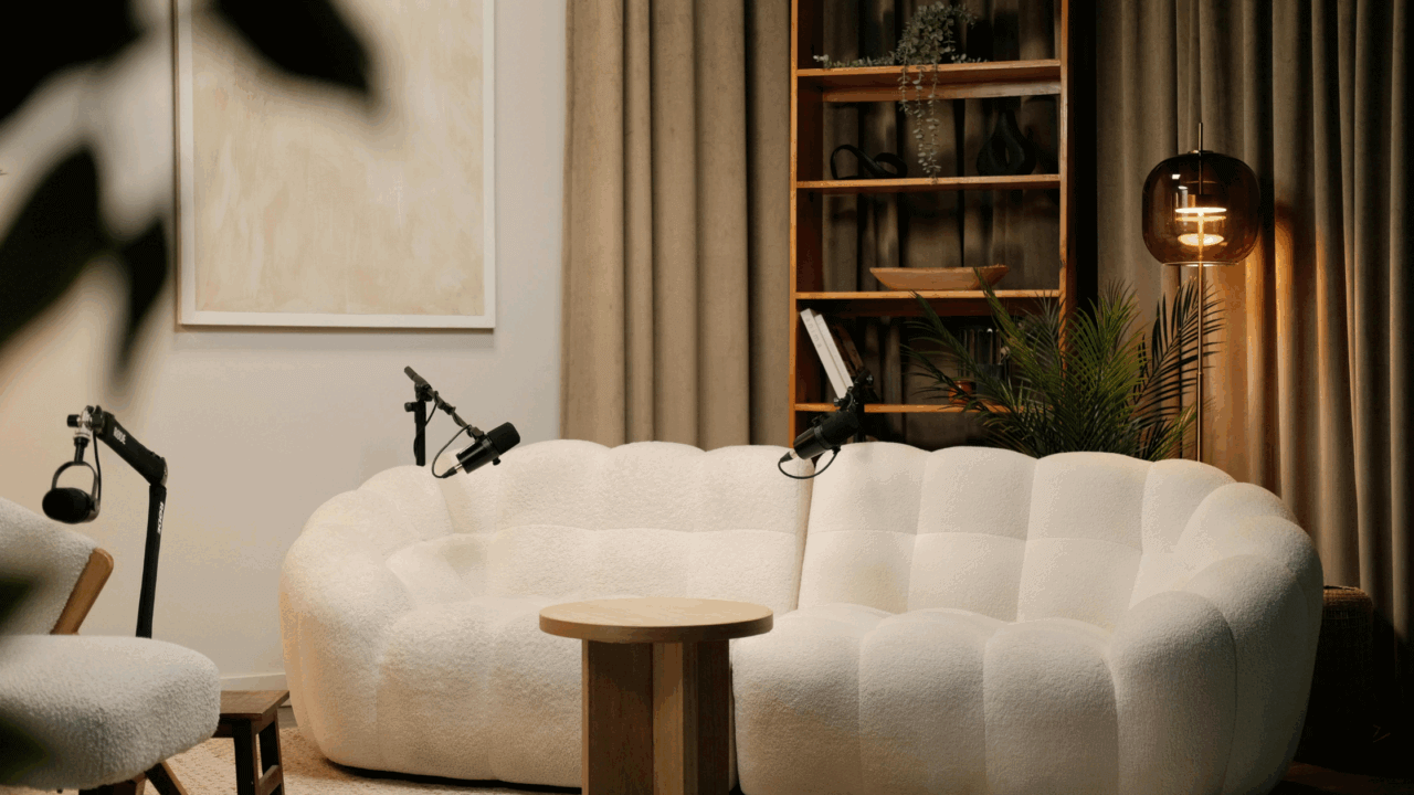 Podcast studio setup with white sofa and microphones, ideal for wedding PR interviews